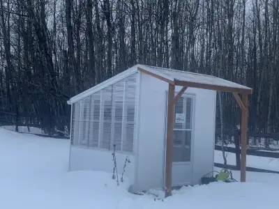 New Greenhouse looks about 10 by 12 ft base. Built with pressure treated lumber. Has fan and two plu...