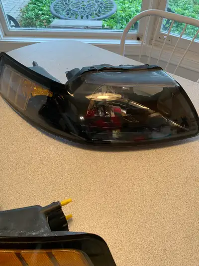 2002 Ford Mustang Halogen headlights, psgr and driver side, chrome housing. (bulbs not included). No...