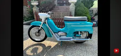 This beautifully maintained vintage Jawa 20 scooter features a striking teal finish and classic desi...
