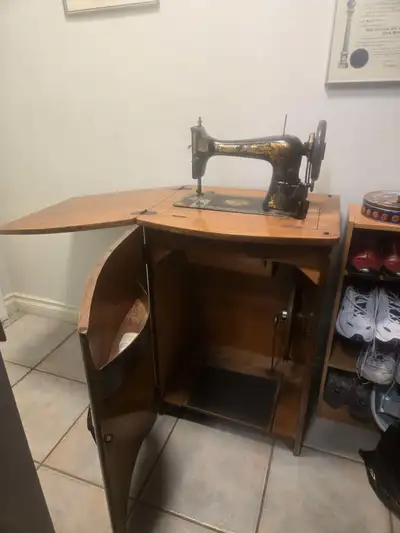 Machine is a treadle style and is settled nicely in its own piece of furniture. This is a lovely pie...