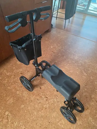 Foldable knee mobility scooter with hand brakes and removable carry basket. Height adjustable handle...