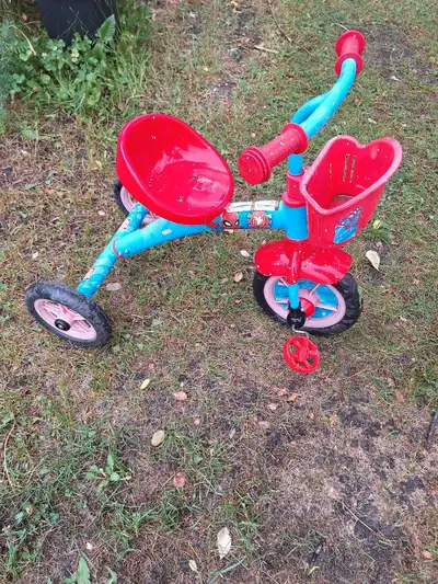 Spiderman tricycle, some missing stickers and paint splatter.