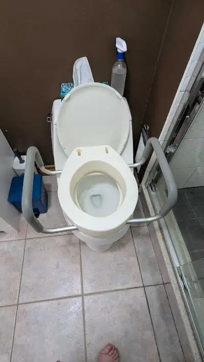 Raised toilet seat with padded armrests , View more