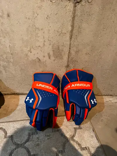 Blue and orange Under Armour lacrosse goalie gloves, View more