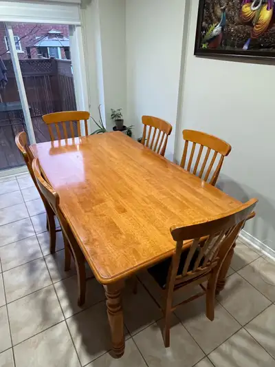 This is a solid wood dining table with six chairs, perfect for family meals or entertaining guests....