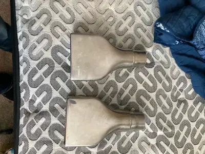 These exhaust ends are used but in good condition. They are made of stainless steel and have a recta...