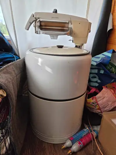 This vintage wringer washer is a classic appliance for laundry, featuring a durable build and effici...