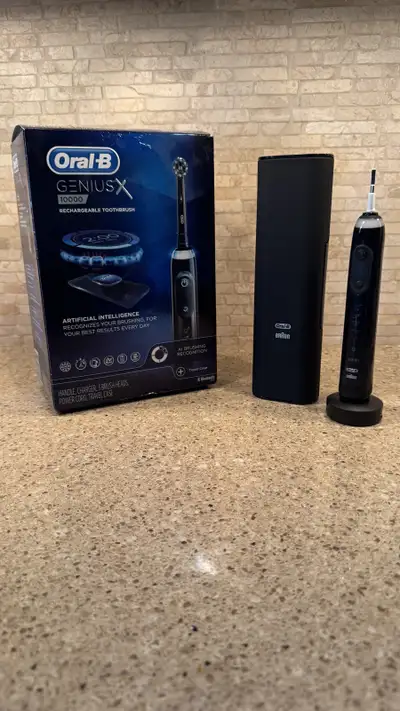 For sale is a like new Oral B Genius X - 10000 model toothbrush with a special edition chargeable tr...