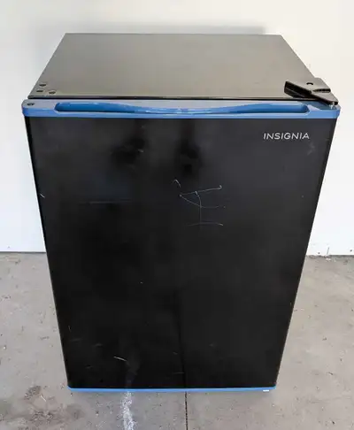 This Insignia mini fridge, while compact and convenient for small spaces, is available as is because...