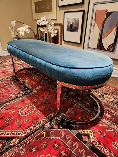 Beautiful teal velvet upholstered bench with unique pill-shaped design and polished chrome legs. Per...