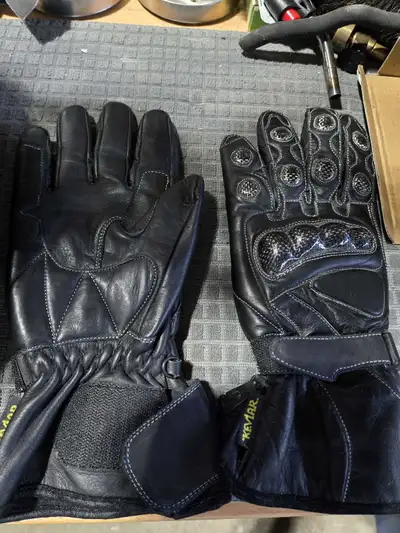 Full length black padded leather/Kevlar motorcycle gloves. Covers hand and just above wrist. Black l...