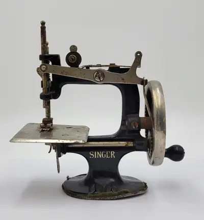 Discover the rich charm of yesterday with this darling Antique Singer toy sewing machine. An heirloo...