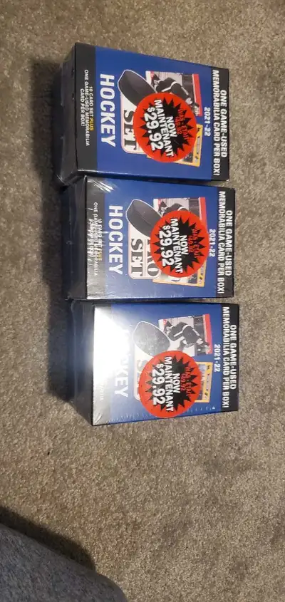 20 dollars each 3 sealed brand new A collection of hockey cards. Boxes are wrapped in plastic. They...