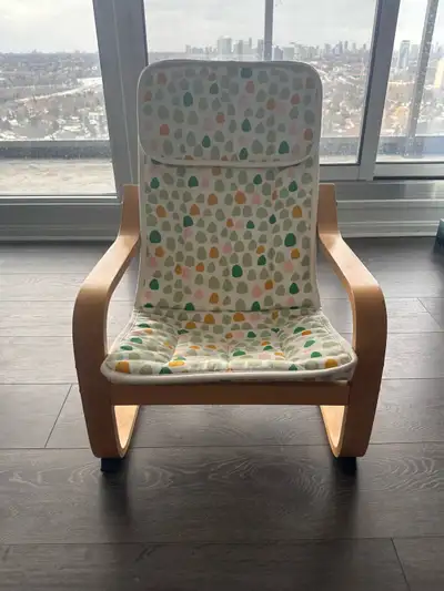 This is a gently rocking Ikea kids arm chair, designed for comfort and relaxation in any nursery or...