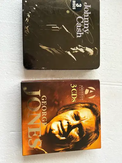 I'm offering a set of used CDs featuring legendary artists Johnny Cash and George Jones, each collec...