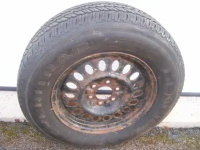 A 245 x 70 r x 17 all seasons tire on steel rim with 8/32 thread left
