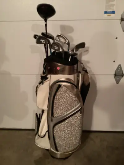 Power bilt golf set bag, irons, putter and metal woods .