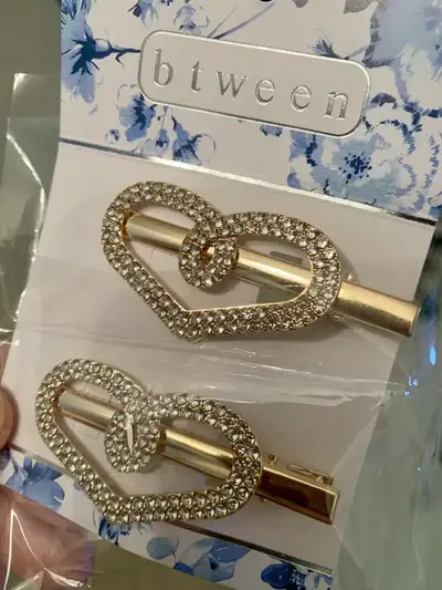 New pair of gold-toned, rhinestone-embellished heart hair clips, View more