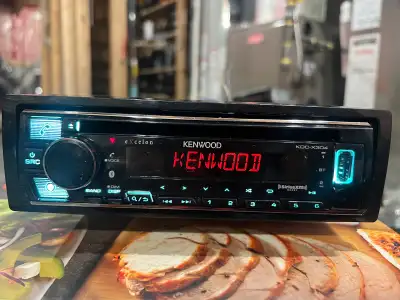 Kenwood KDC-X304 CD receiver with AM/FM tuner, USB, Bluetooth, Sirius XM. Plays media loaded with MP...