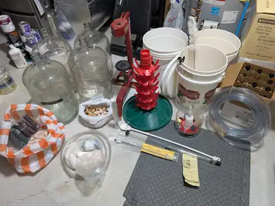 Extensive home winemaking equipment kit. Includes four large glass carboys, three white plastic ferm...