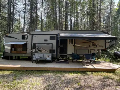 This well maintained Fifth Wheel features: • 4 Slides -Master bedroom with king size mattress, dress...
