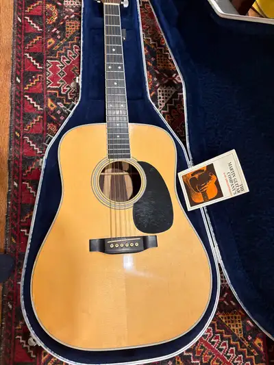 Martin D-35 with original hard shell case has a few dings, lacquer grackling and repaired crack on t...