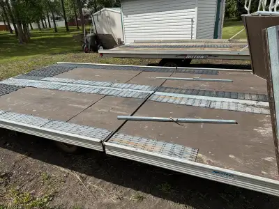 14’ ( 16’ at the V) trac pac sled trailer. Double independent tilt drive on drive off. New 3/4” deck...