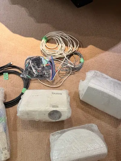 For sale is a used BenQ projector, perfect for home theaters or presentations, accompanied by speake...