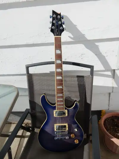 This is a M600 Cort Guitar, Blue sunburst. Has coil split., Made in Indonesia. This their version of...