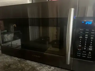 Samsung Over The Range Microwave. 1.8 cubic feet. Black stainless steel. Has a simple clean filter....
