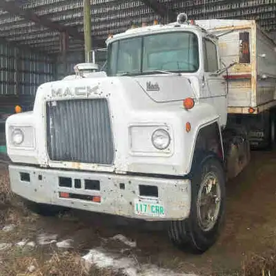 For sale Mack R686 diesel tandem grain truck. Has 20ft CIM grain box, 3 piece end gate, scissor hois...
