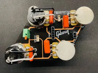 Newer versions of the Gibson Les Paul and SG circuit boards (with the white 5-pin Quick Connect pick...