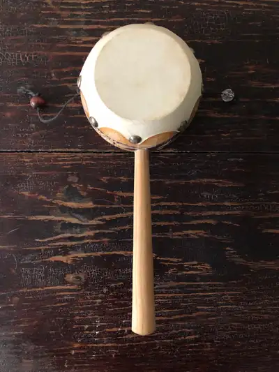 Mexican Spinning Drum, also known as a Monkey Drum or Rattle Drum It features a drumhead (often made...