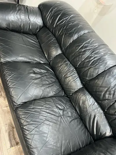 Selling a gently used black leather couch in good condition. This 3-seater sofa is spacious, comfort...