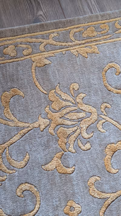 Very high-end imported carpet. Muted sage green background with gold design details. 5'5" x 8'6" Ori...