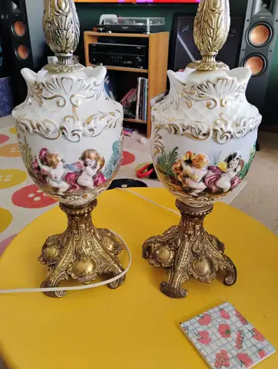 These elegant matching antique lamps feature beautiful porcelain bodies decorated with cherubs and i...
