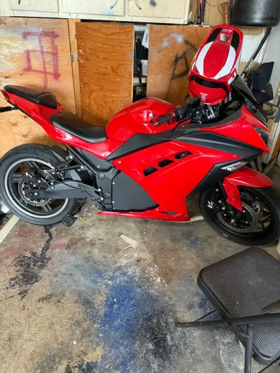 This Emotorcycle is a sleek, red electric motorcycle that offers a thrilling and eco-friendly riding...