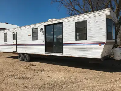 38’ park model trailer. Ready to move in. Propane tanks included. Furnace and stove and fridge and h...