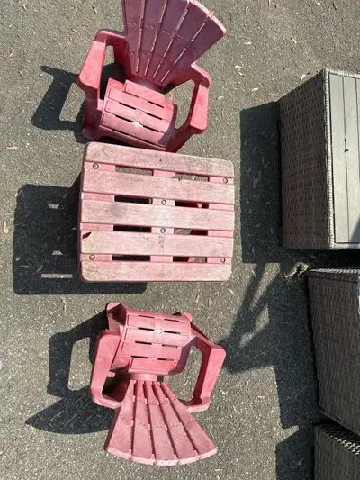 This used children's red Adirondack-style table and chairs set is perfect for any backyard or play a...