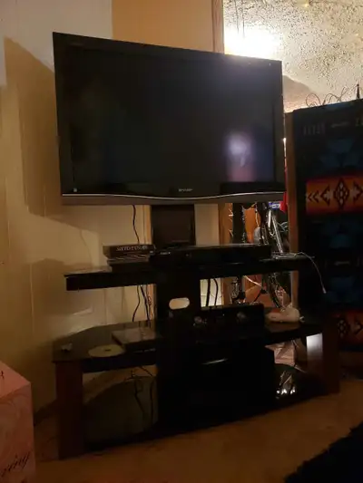 Brand new TV stand, speakers and 32 inch TV...plus a box of dvds blu ray dis player Doesn't come wit...