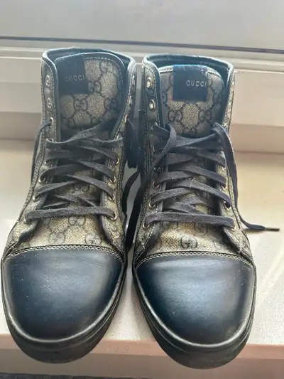 Step out in style with these authentic Gucci high top sneakers, featuring the iconic GG monogram can...