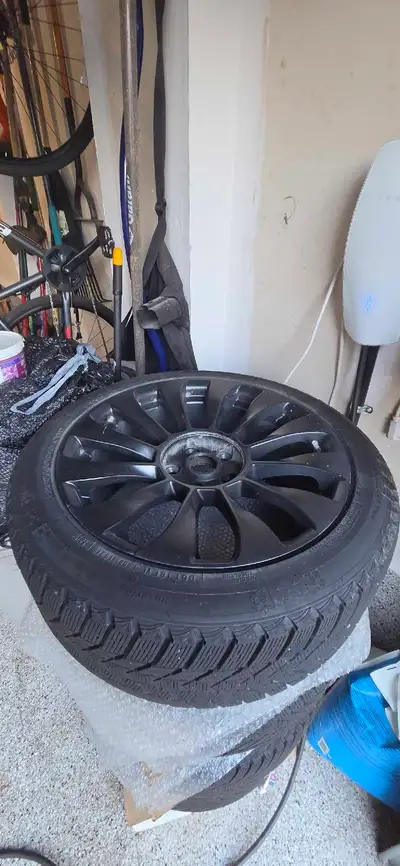 Nexen Winguard Ice Plus snow tire. Size 235/45R18 98T. Mounted on a black 18-inch alloy wheel. Wheel...
