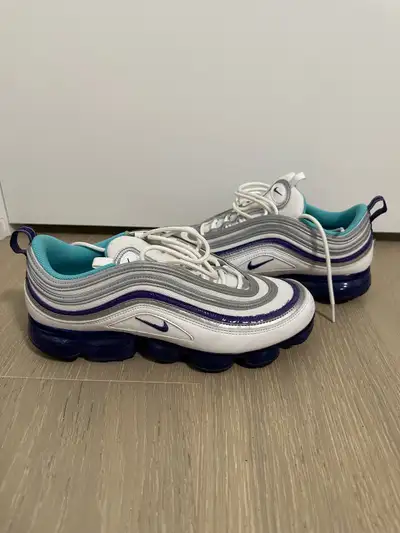Step out in style with these Nike Air Vapormax 97s, featuring a sleek white, varsity purple, and aqu...