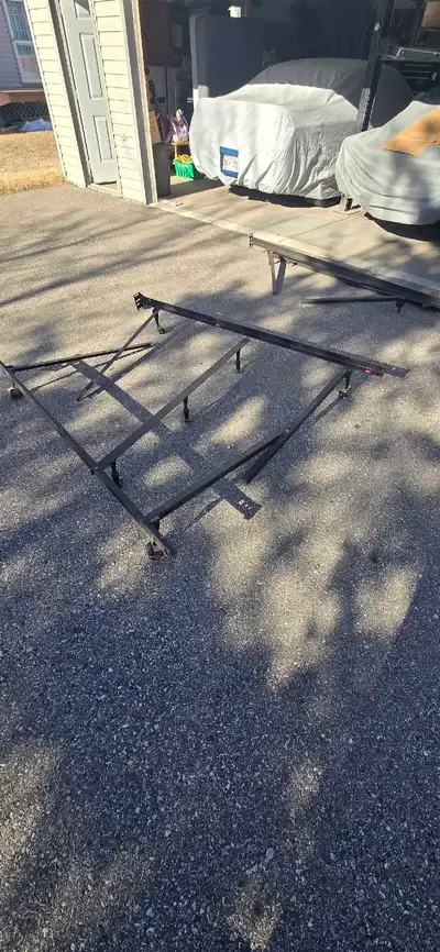 This metal queen-sized bed frame offers sturdy support for your mattress, easily fitting into any be...