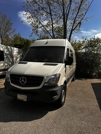 Full-size Cargo Van 2.1L Inline4Cyl RWD Has back seats, partition wall, hitch receiver, 9ft cargo sp...