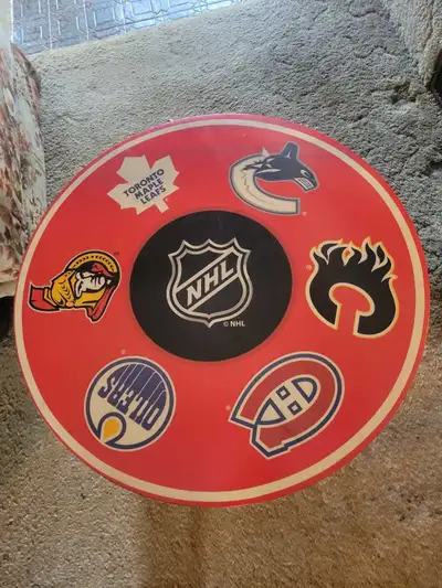 I have a NHL Canadian teams folding bistro table for sale. It displays six of the seven Canadian NHL...