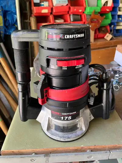 A Craftsman model 175 corded woodworking router, with integral work light and dust collection bag, 1...