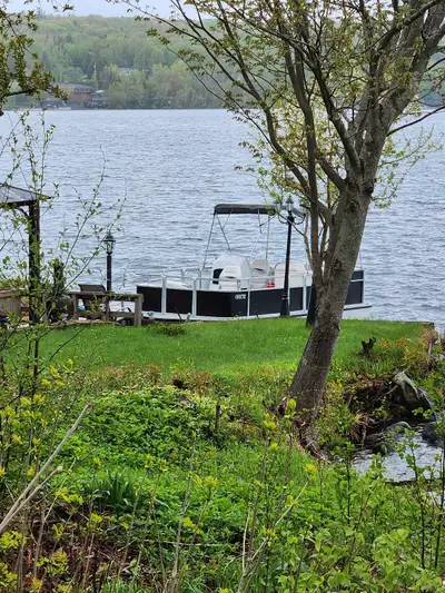 This is a used Harris Flat deck boat measuring 21 ft, perfect for leisurely cruises and entertaining...