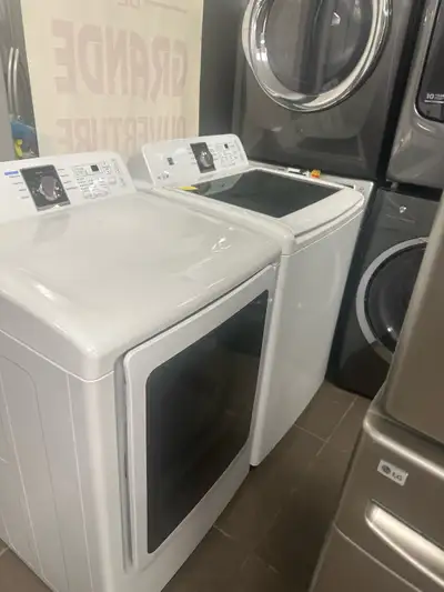 This is a used Samsung washer and dryer. It features a top-load washer and front-load dryer. This se...
