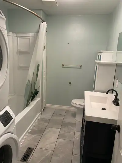 Bright and welcoming room for rent featuring hardwood floors in the common area and access to a clea...